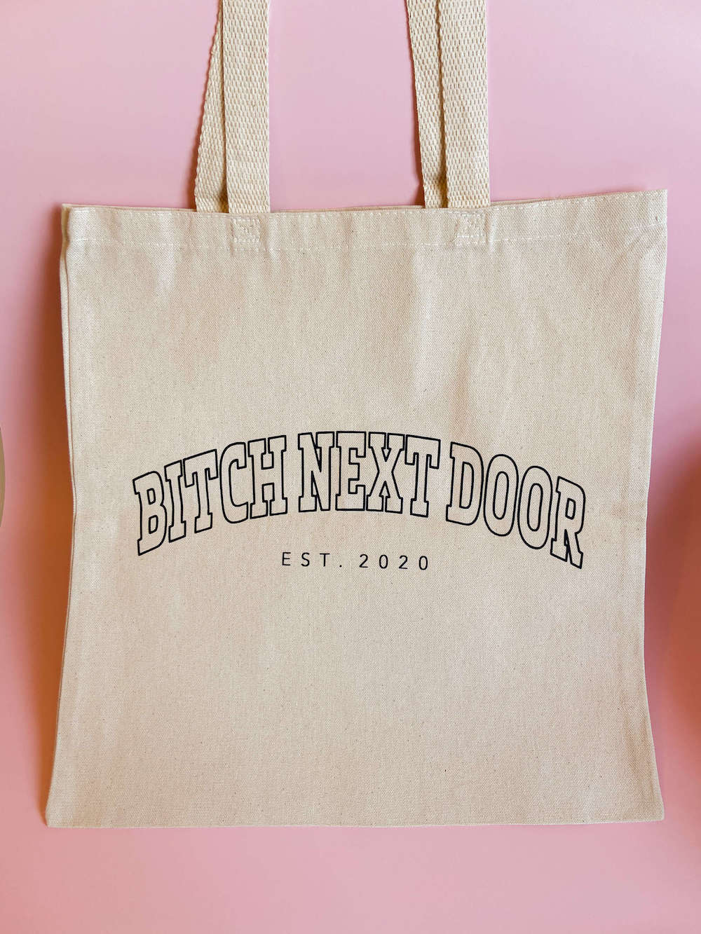 signature Bitch Next Door tote bag. black outlined text