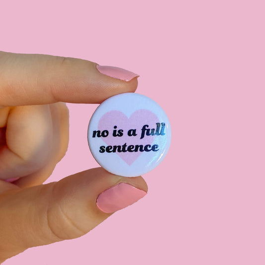 white and pink button reading "no is a full sentense"