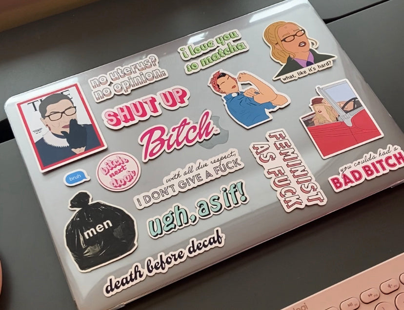 bitch next door stickers all over a laptop