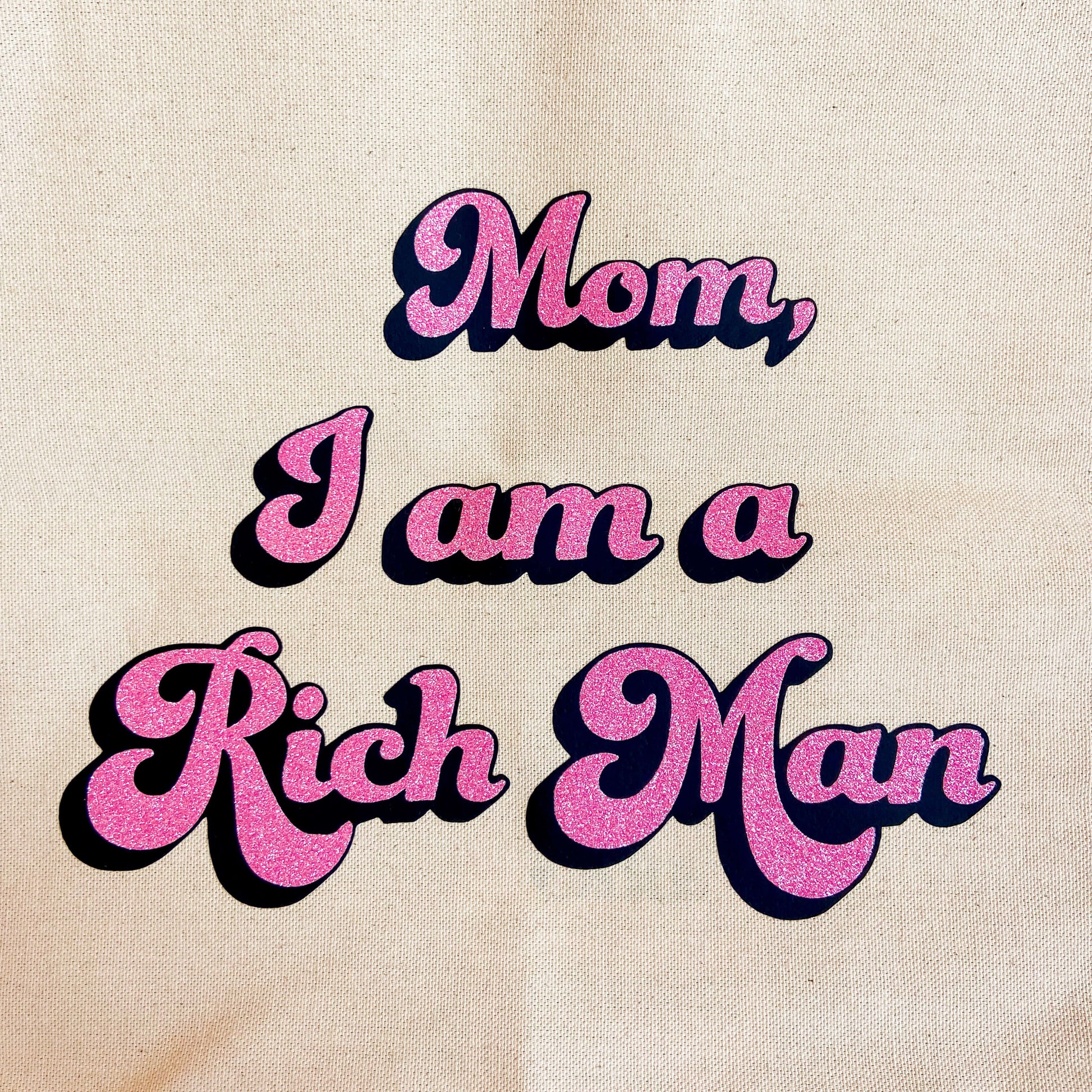 Burlap tote bag with pink glitter text reading "mom i am a rich man"