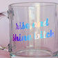 clear mug with reflective text reading "rise and shine bitch"