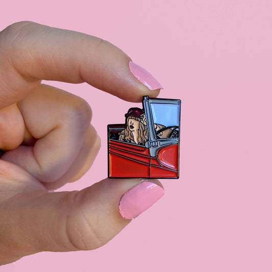 enamal pin of taylor swift in a red car as in her song all too well (ten minute version)